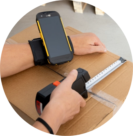 Measuring A Box With A Cell Phone In Hand, Focused On Ensuring Accurate Dimensions